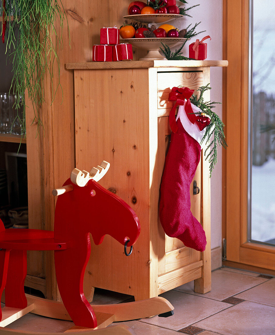 Santa stocking hung on a chest of drawers