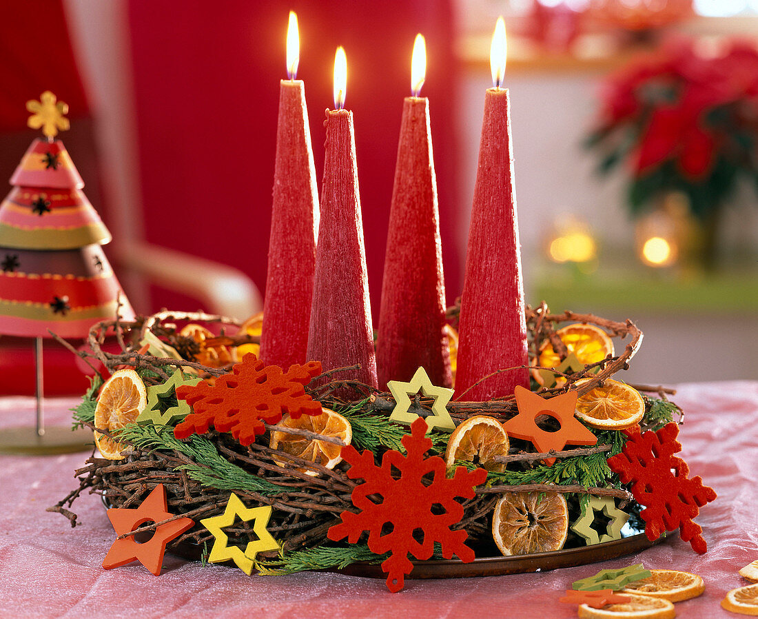 Advent wreath with red candles made of branches of Larix (larch)