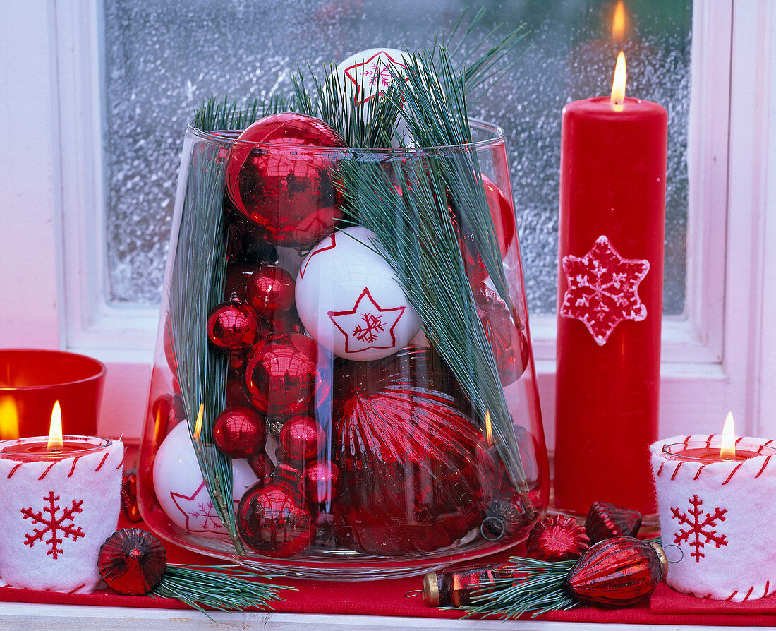 Red and white Christmas tree balls and Pinus (silk pine) in glass