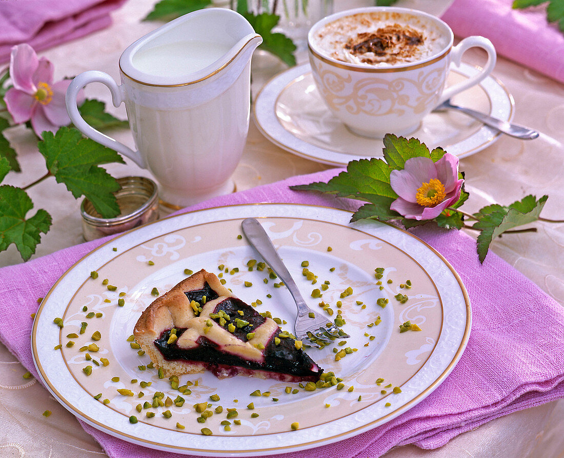 Anemone hupehensis, blackberry cake with chopped pistachios