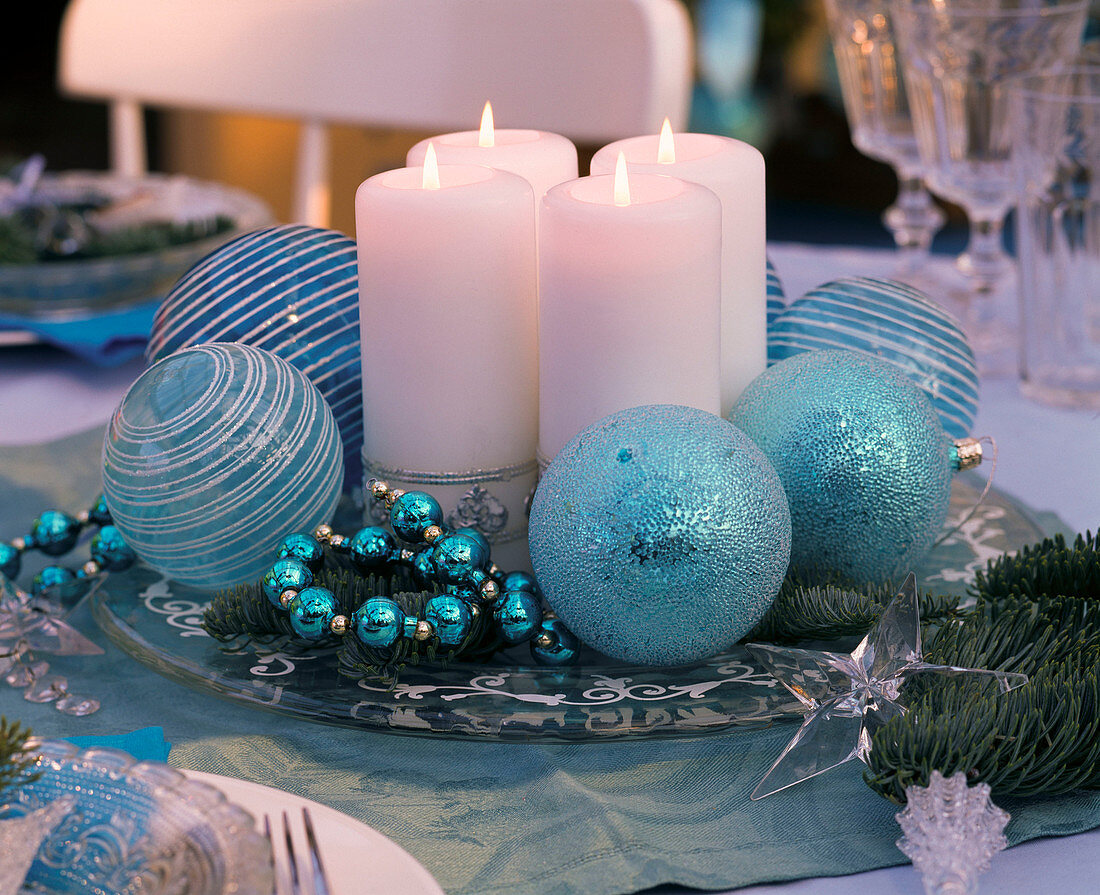 Unusual advent wreath with white candles on glass plate