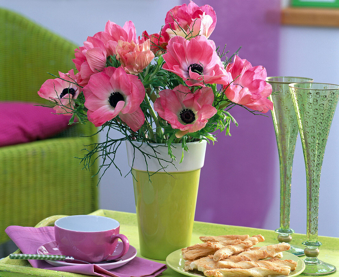 Bouquet of anemones in green vase with white border