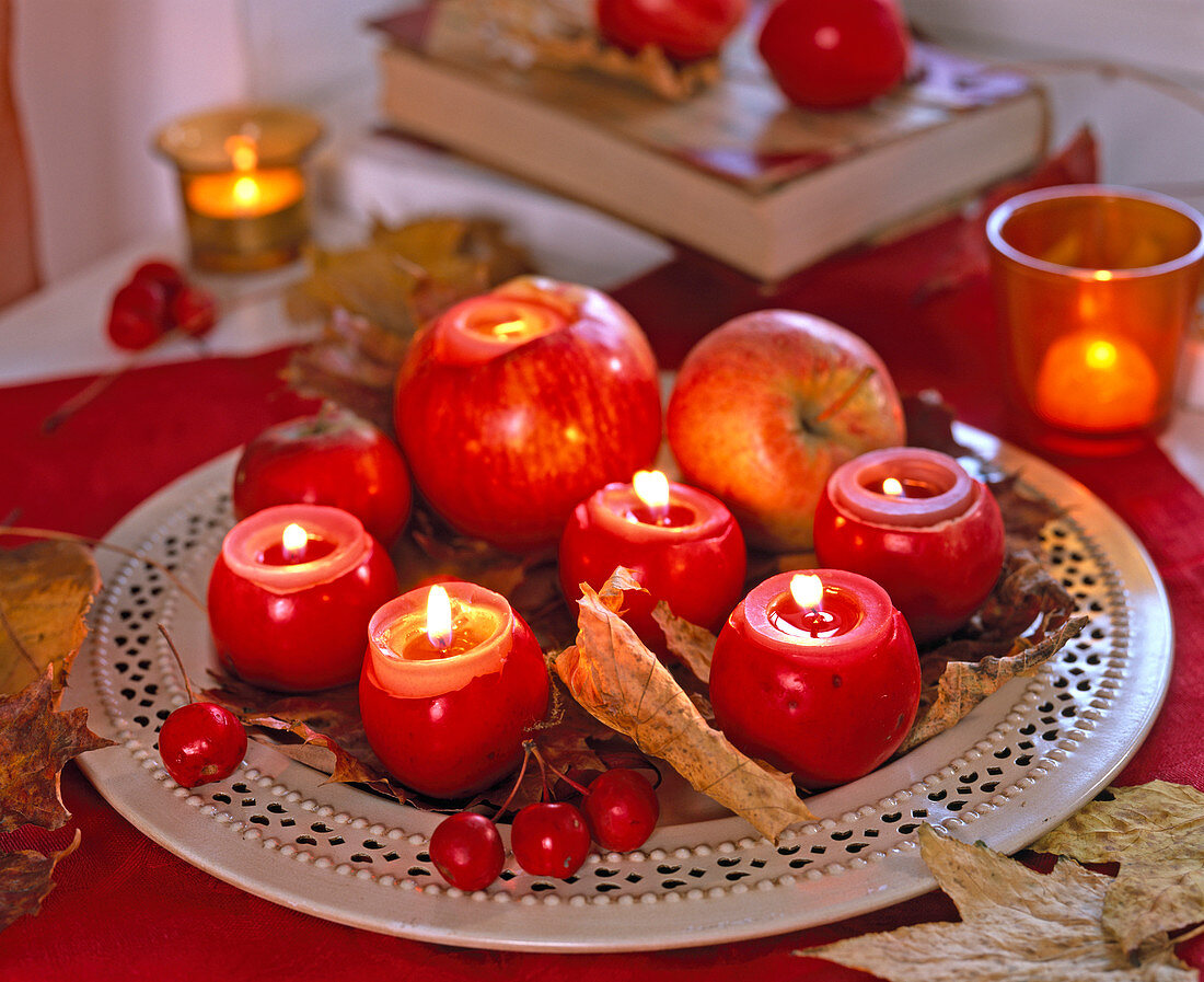 Apples as tealight holder on metal dish