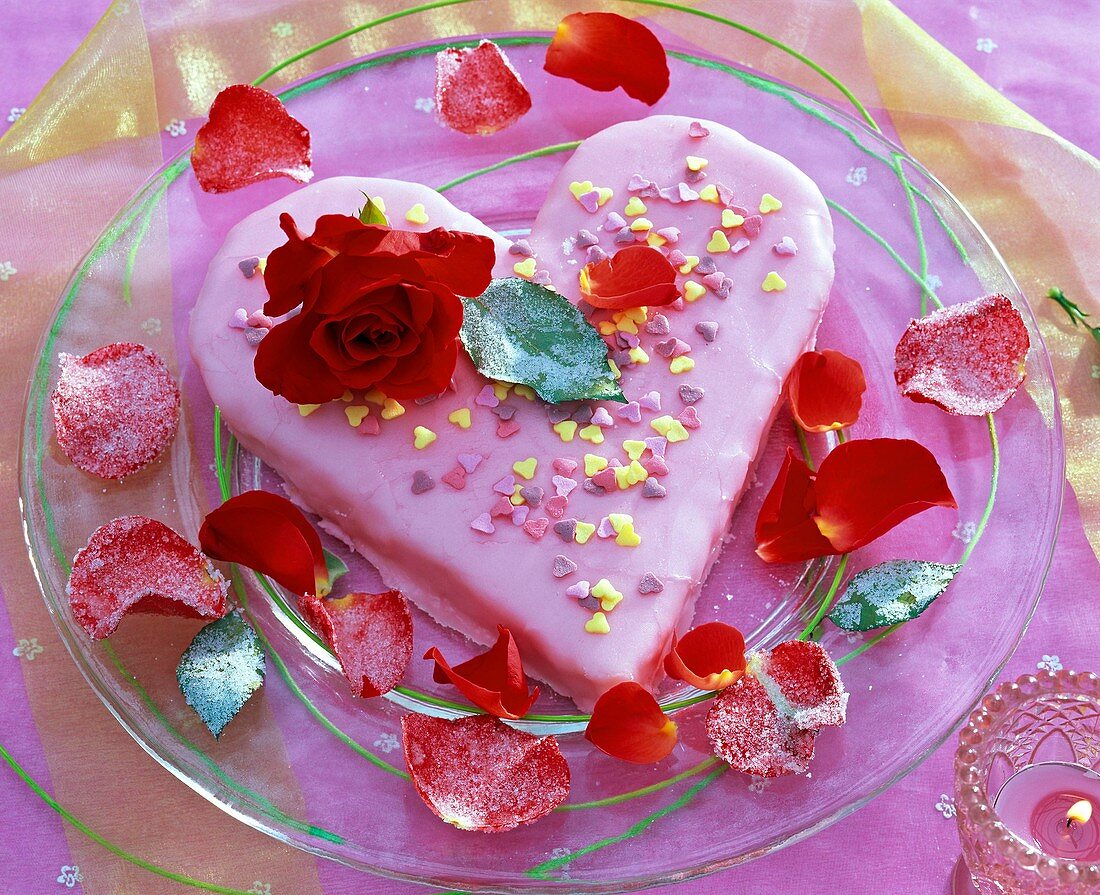 Cake with blossom of pink, petals on glass plate