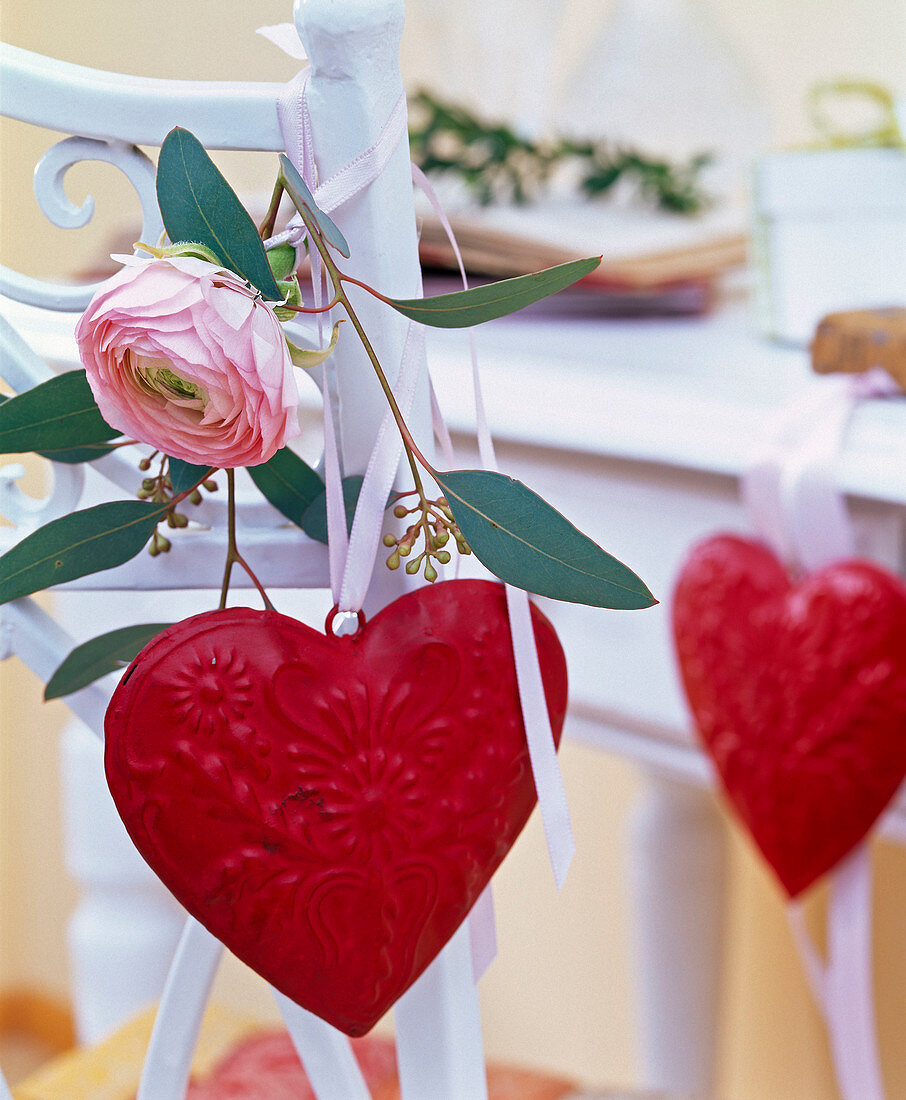 Blossom of ranunculus (ranunculus), eucalyptus and red tin heart