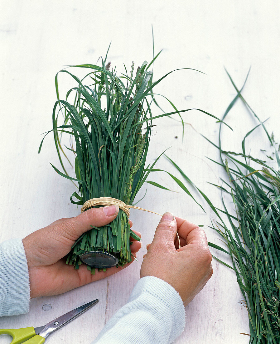 Bouquets in bottles on grass coat