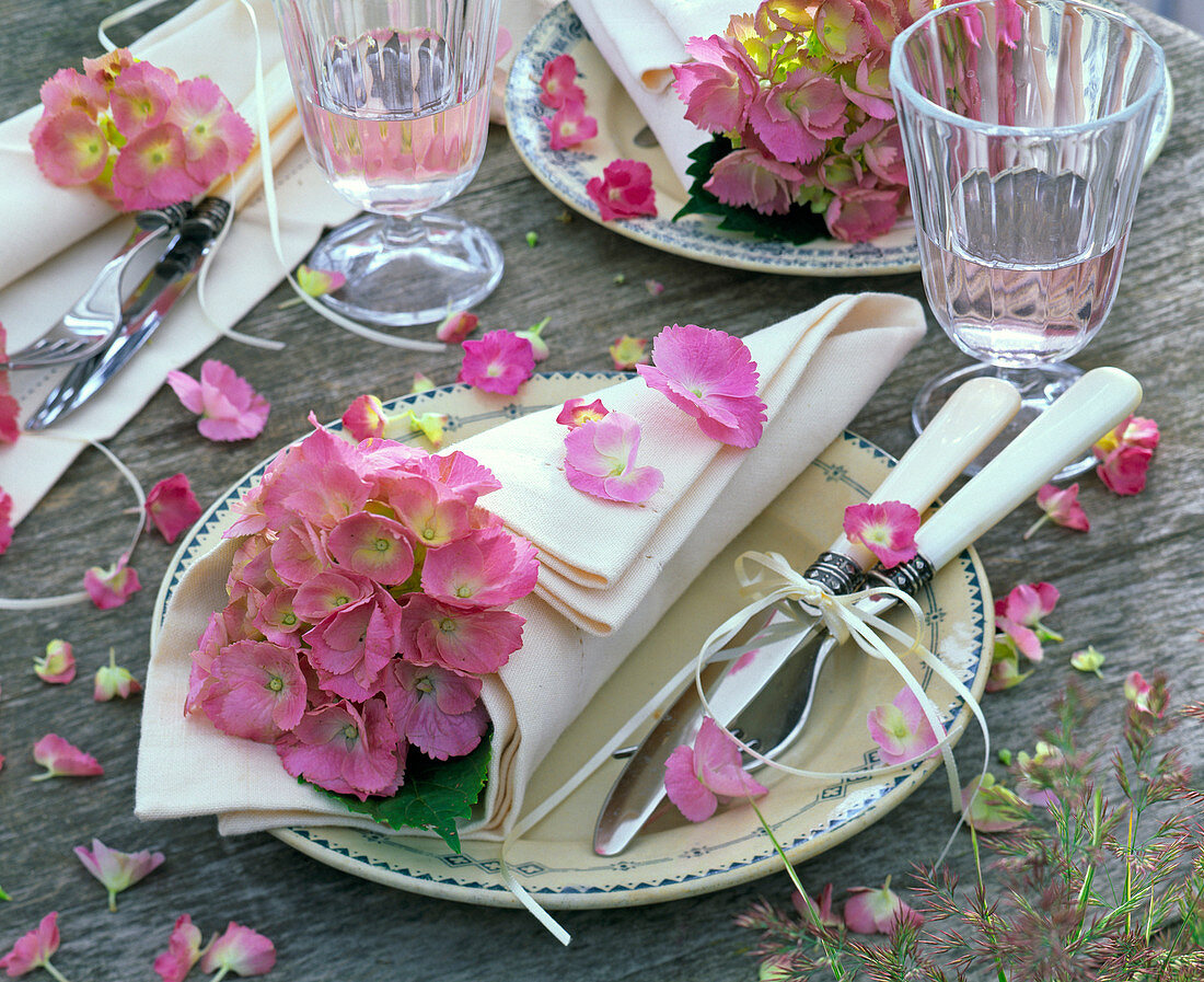 Hydrangea flowers in a white, bag-like rolled napkin