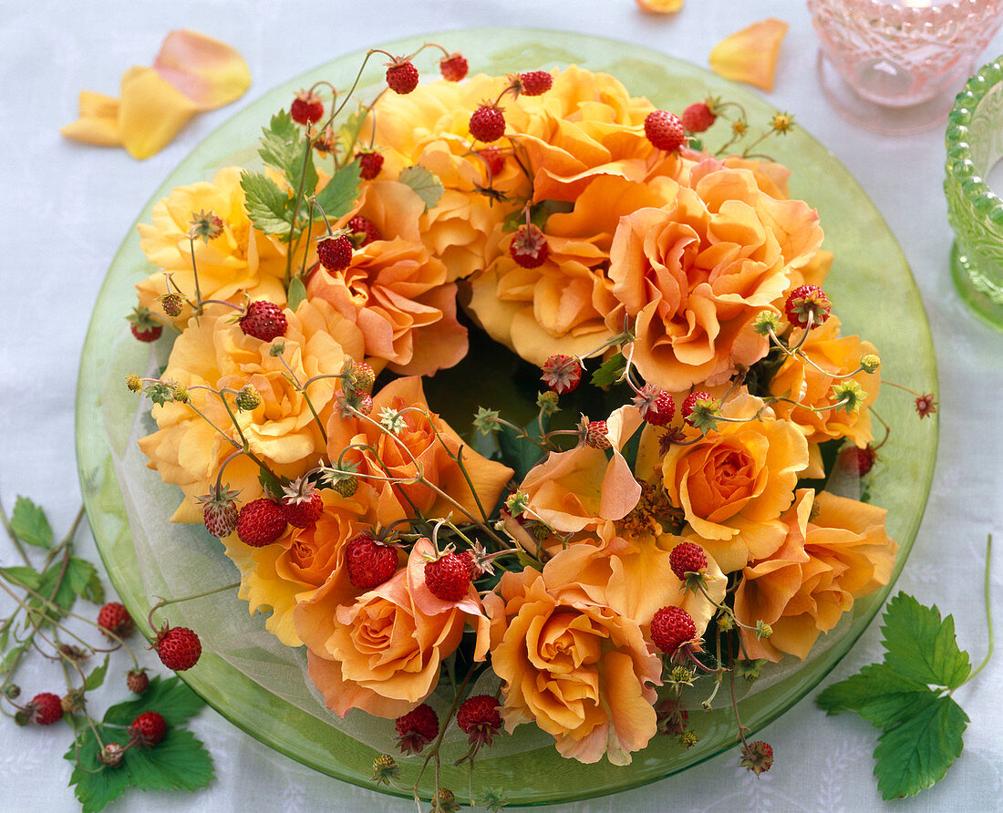 Wreath of flowers of pink (rose) and Fragaria tendrils