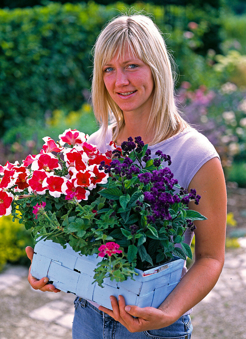 Woman with plants in a light blue basket