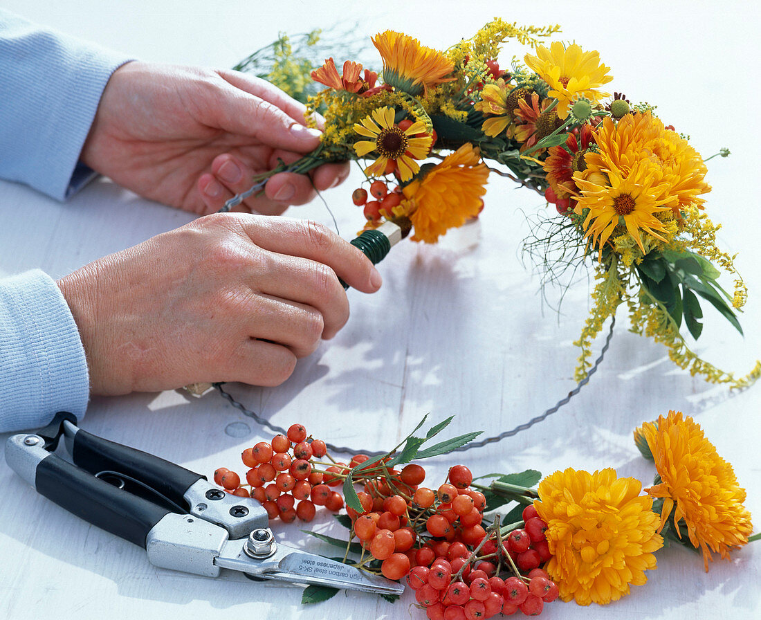 Late summer wreath with marigolds and rowanberries