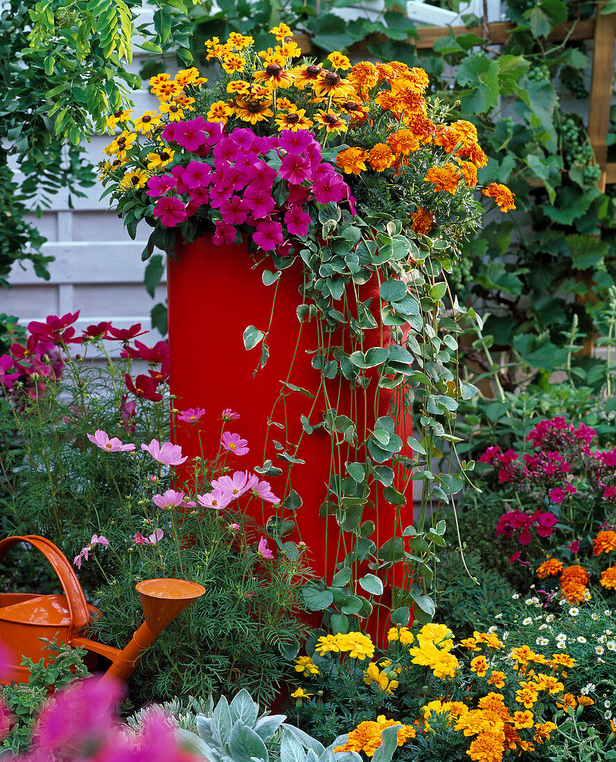 High red plastic tub buried in the flowerbed