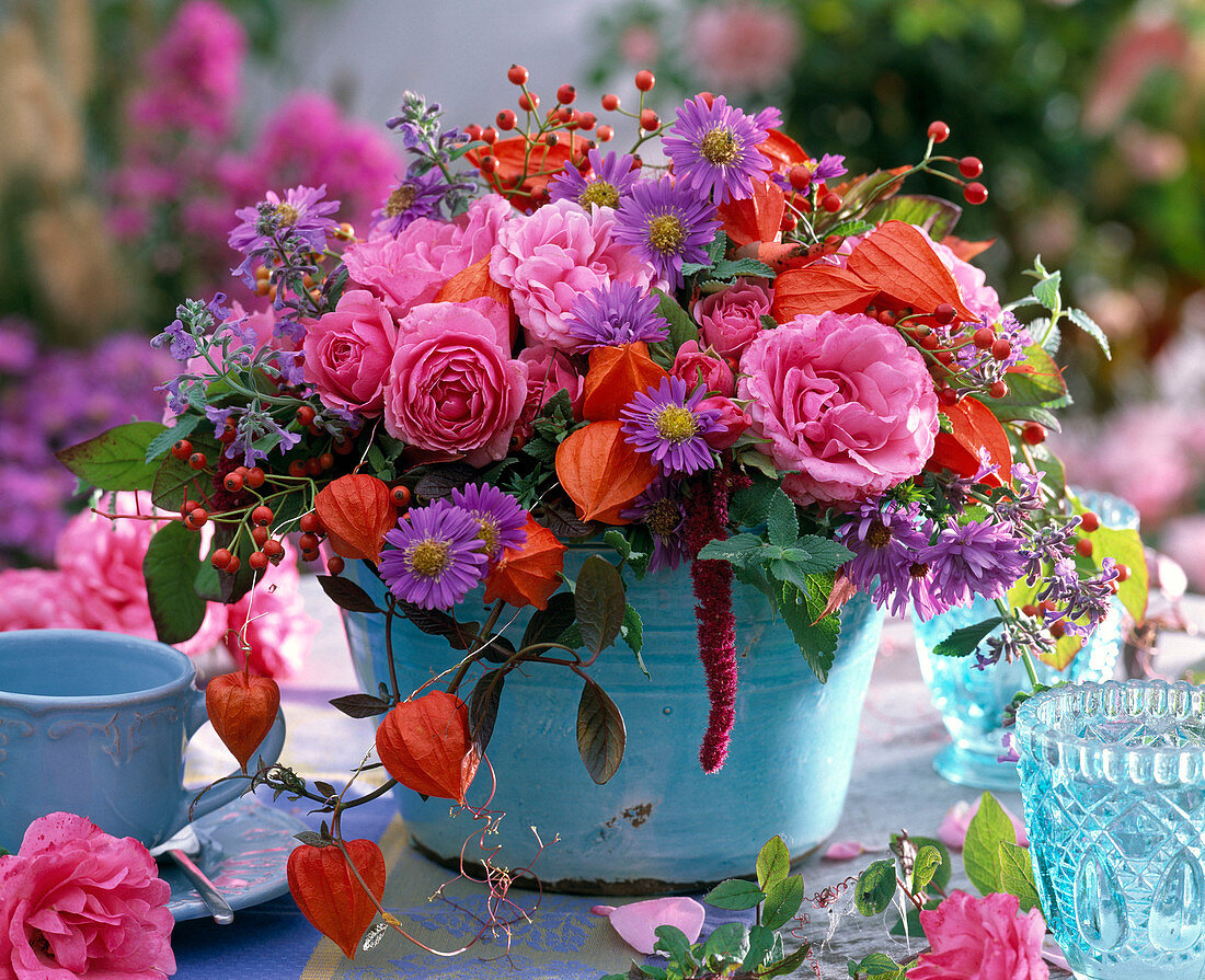 Autumn arrangement with roses, asters, physalis