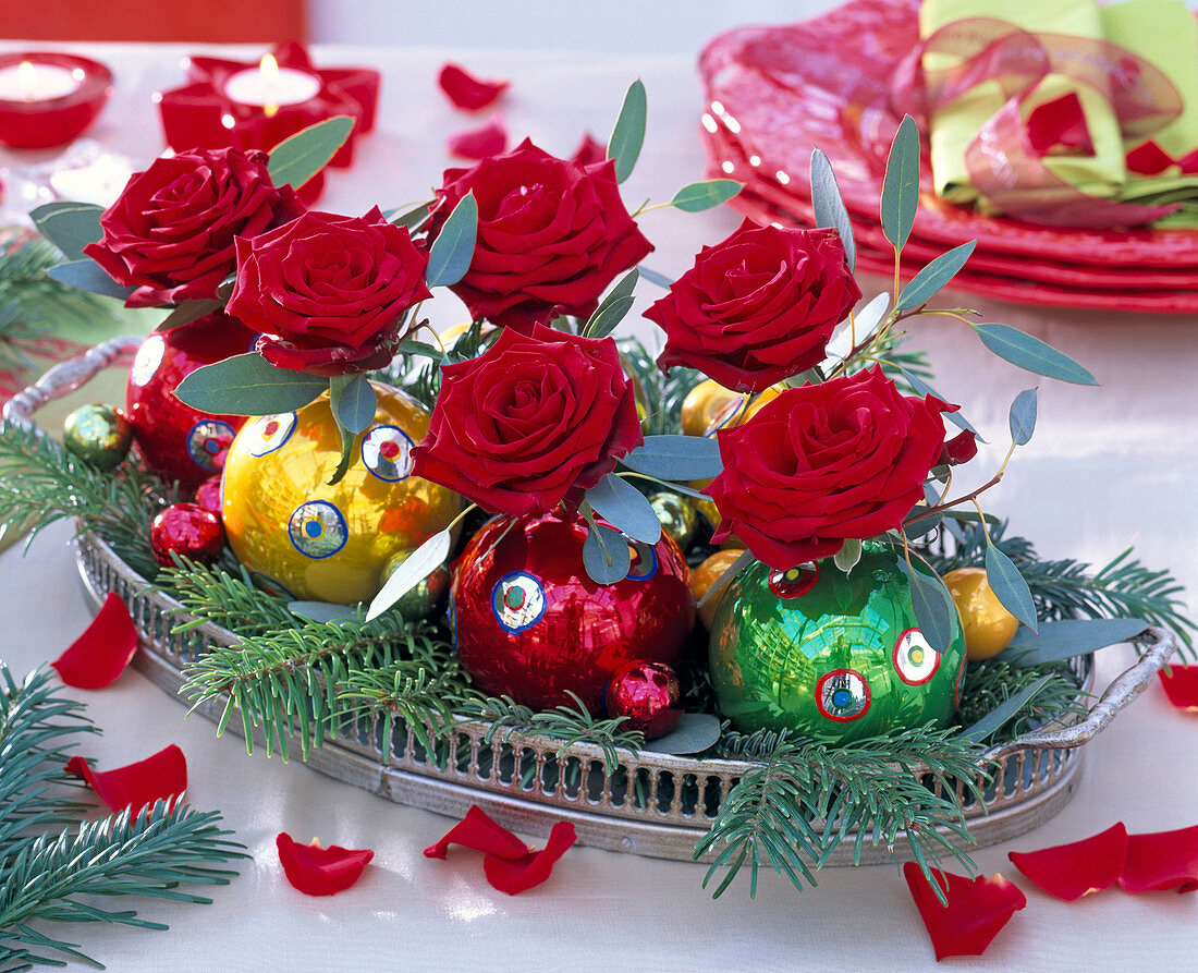 Red Rosa 'Passion', Eucalyptus, in Christmas tree balls as vases