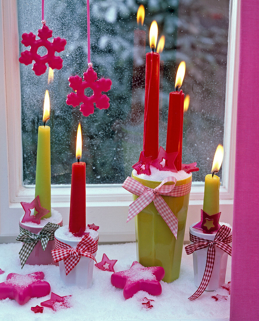 Burning candles on the windowsill