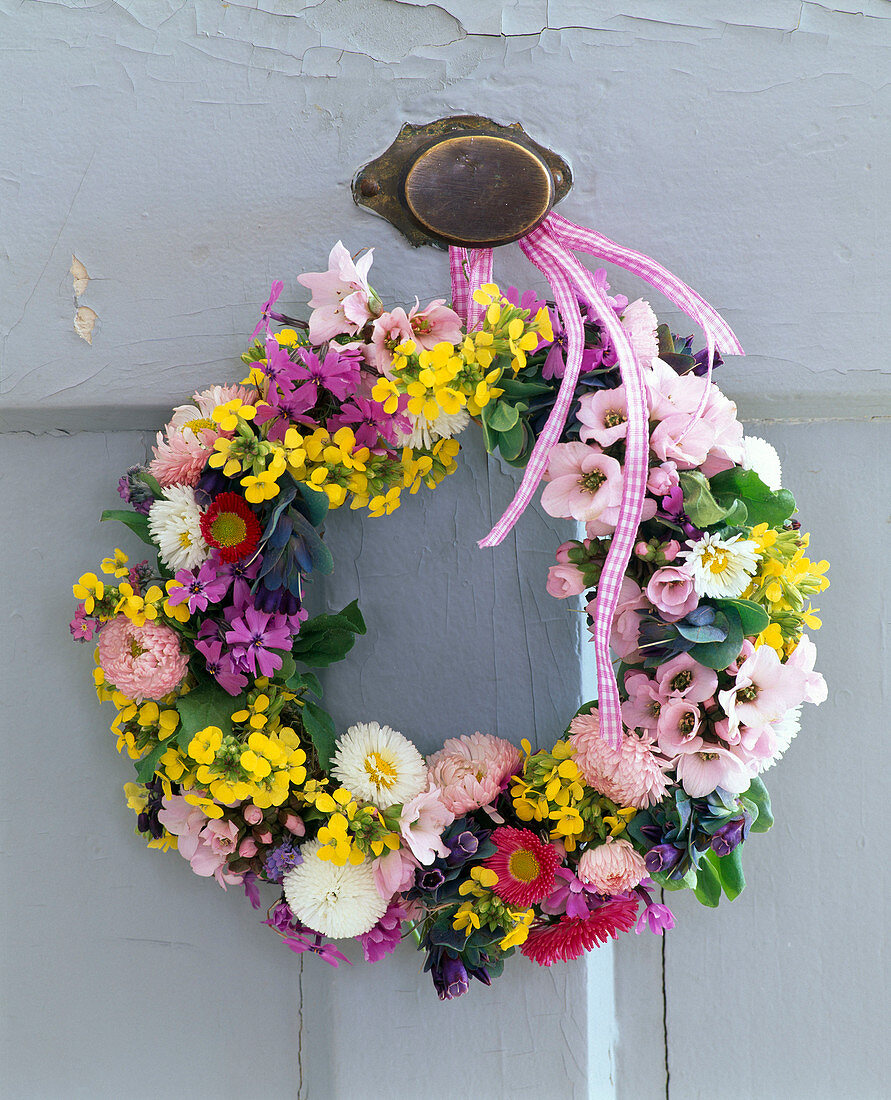 Door wreath from Bellis (daisies), Erysimum (gold paint), Prunus