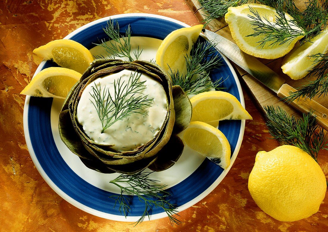 Artichoke stuffed with Garlic Yogurt decorated with Dill and Lemon Wedges