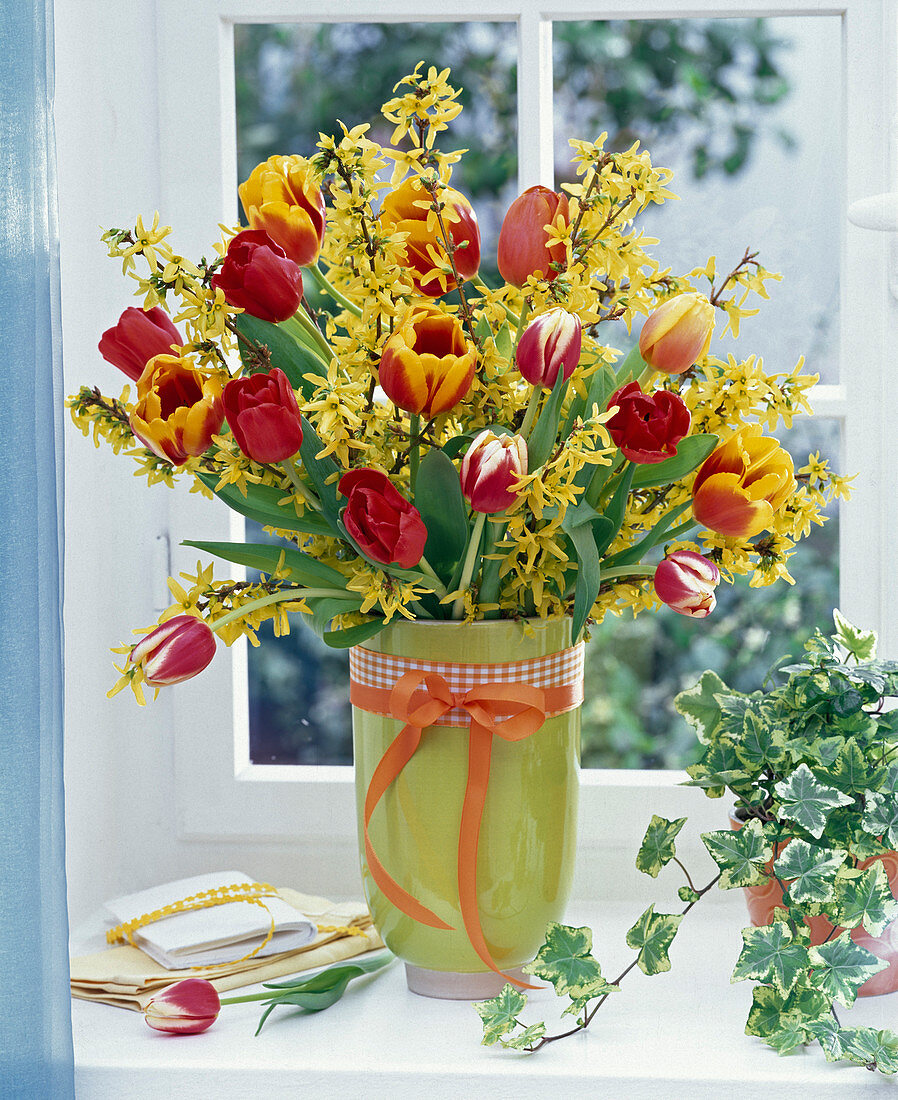 Bouquet made of forsythia branches and tulips stems