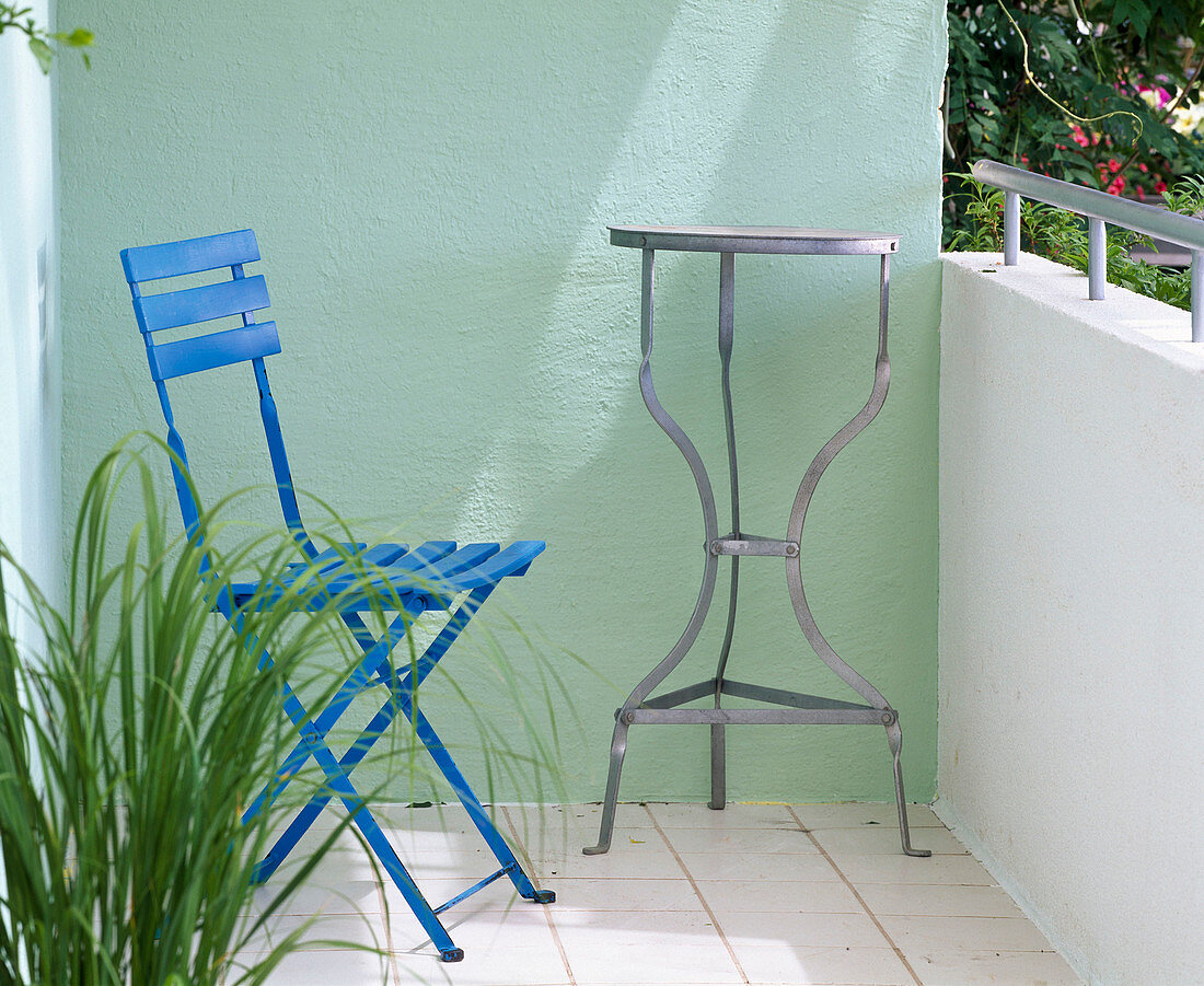 Before-after balcony: blue folding chair, table, light green wall
