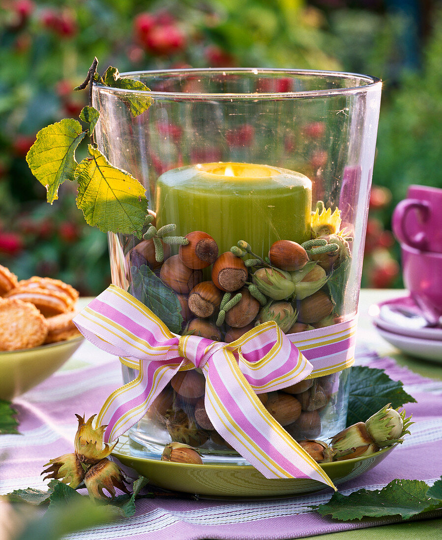 Lantern with Corylus (hazelnuts), green candle and bow