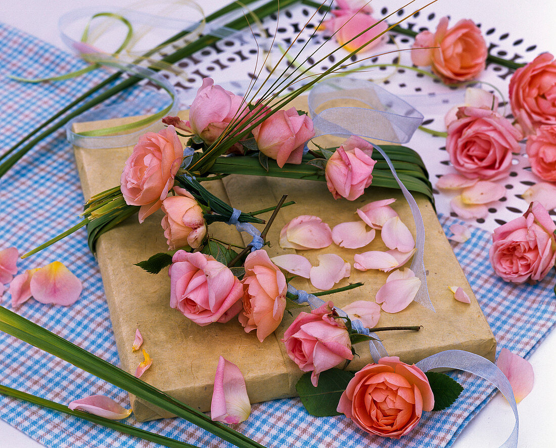 Gift decorated with spartina (golden rye grass), pink (roses) and petals