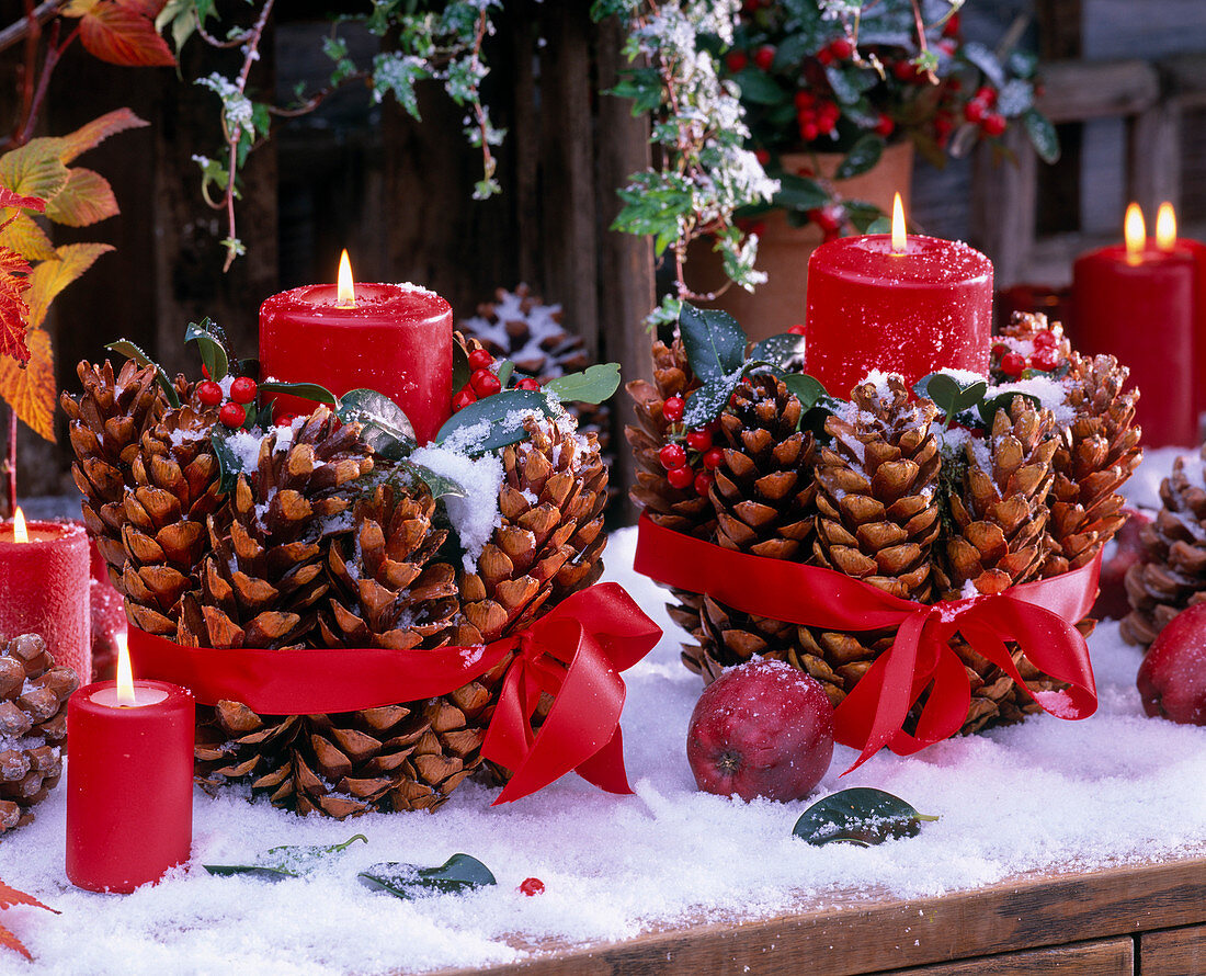 Red candles with spruce cones