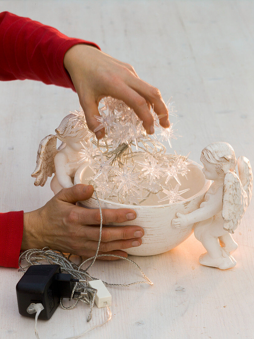 Roses and Christmas tree decorations in bowl with angels (2/4)