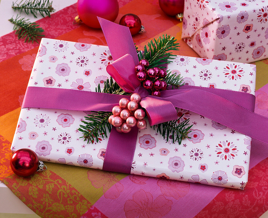 Gift with pink ribbon, Abies (fir branches)