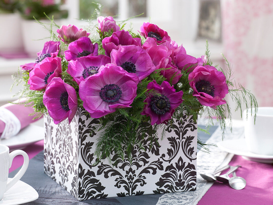 Bouquet with anemone coronaria (crown anemone) and asparagus