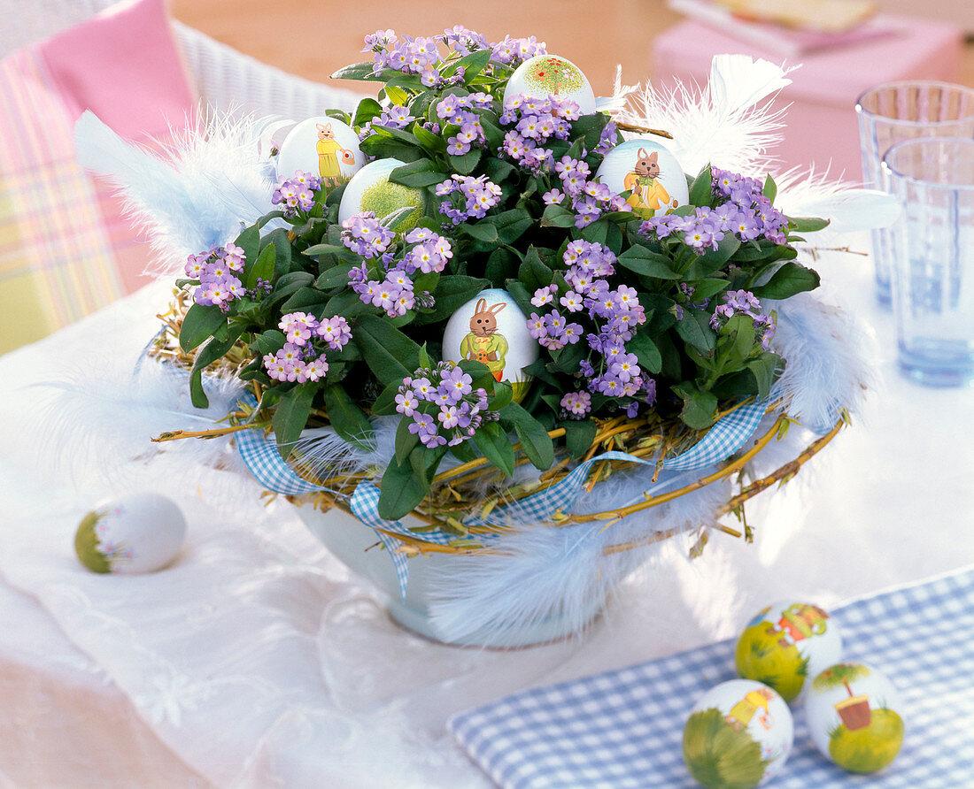 Myosotis 'Myomark' (forget-me-not) with a wreath of Salix (willow), Easter eggs