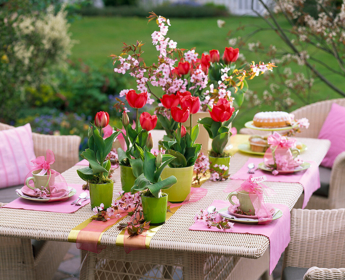 Table decoration with tulips and ornamental cherry blossoms