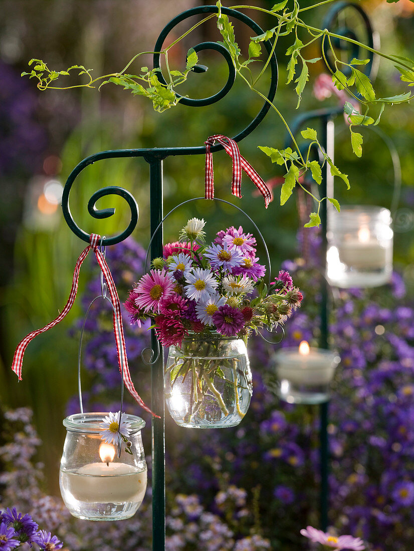 Small bouquet of aster (white wood aster) and floating candles