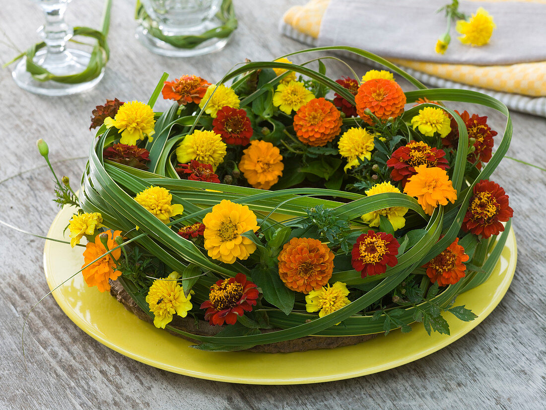 Wreath arrangement with Spartina (golden marigold) and Tagetes