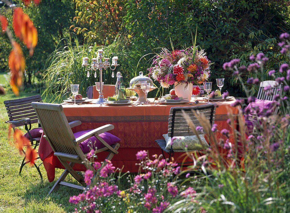 Laid table in the garden with late summer bouquet