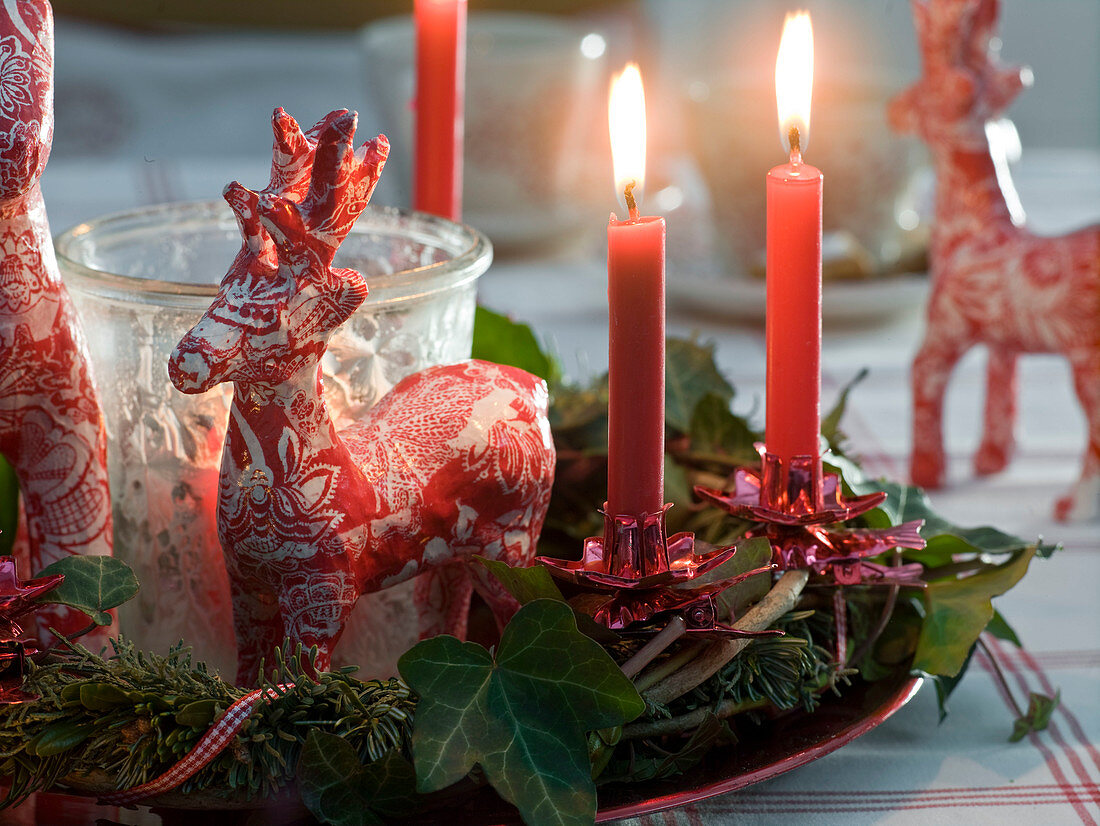 Reindeer made of papier-maché a wreath of Abies (fir)