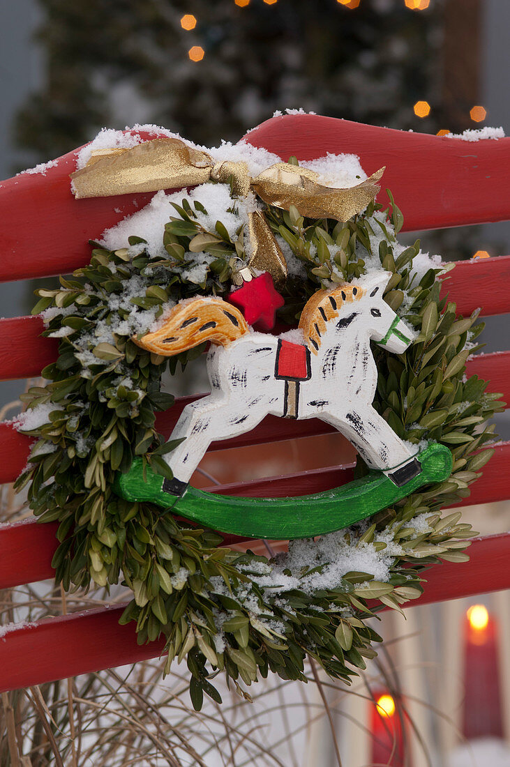 Wreath of Buxus (boxwood) with wooden rocking horse