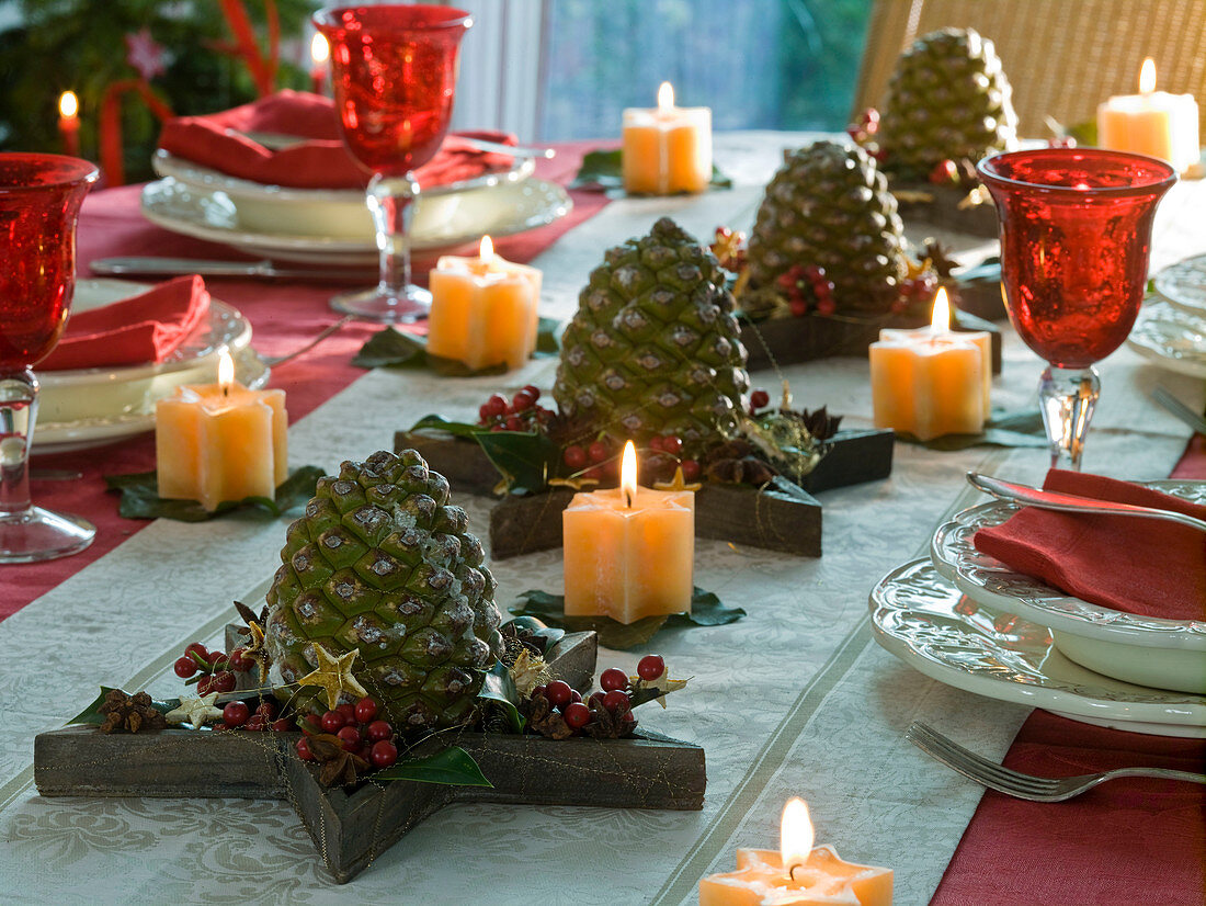 Christmas table decoration with Pinus (pine cone) on wooden stars