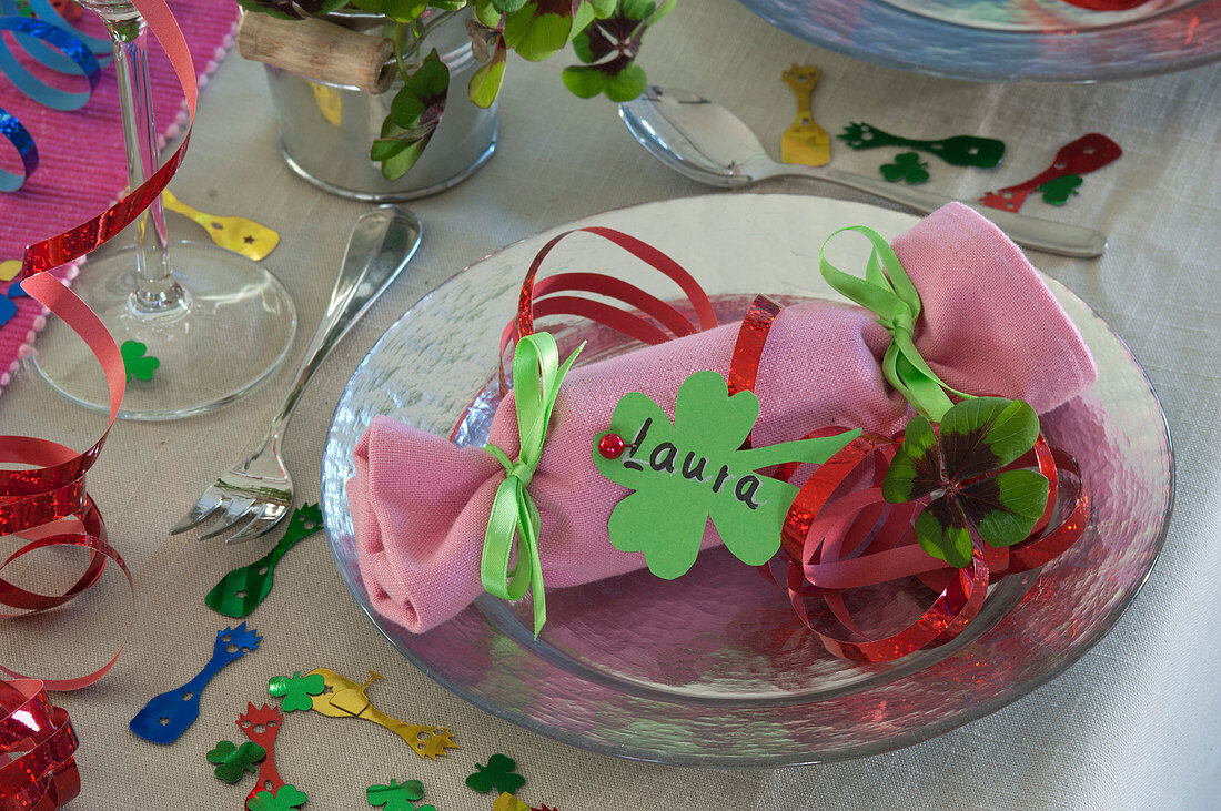 Bright red velvet flowers as place card for New Year's Eve table decoration