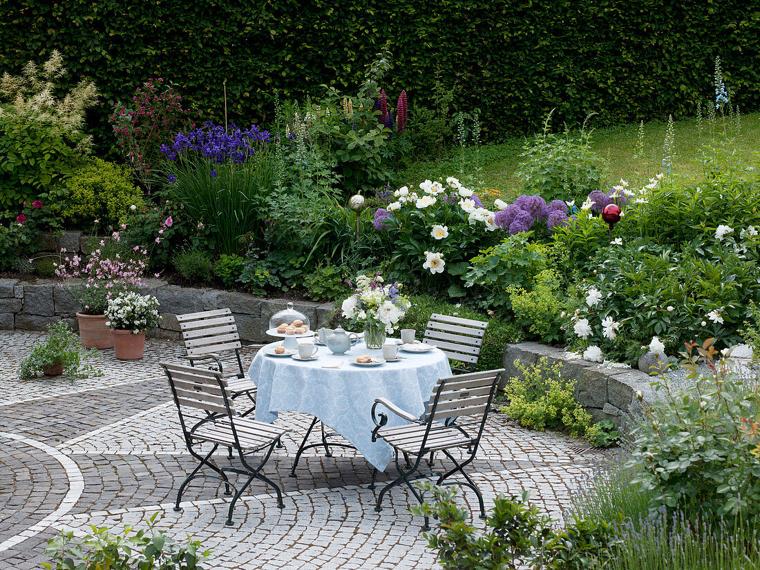 Seating group with covered table on paved terrace