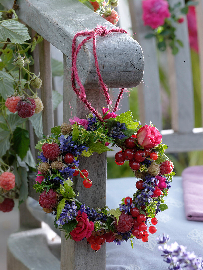 Herb and berry wreath hung on an armrest