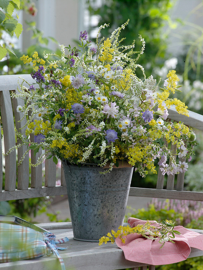 Bouquet of meadow flowers in a zinc bucket
