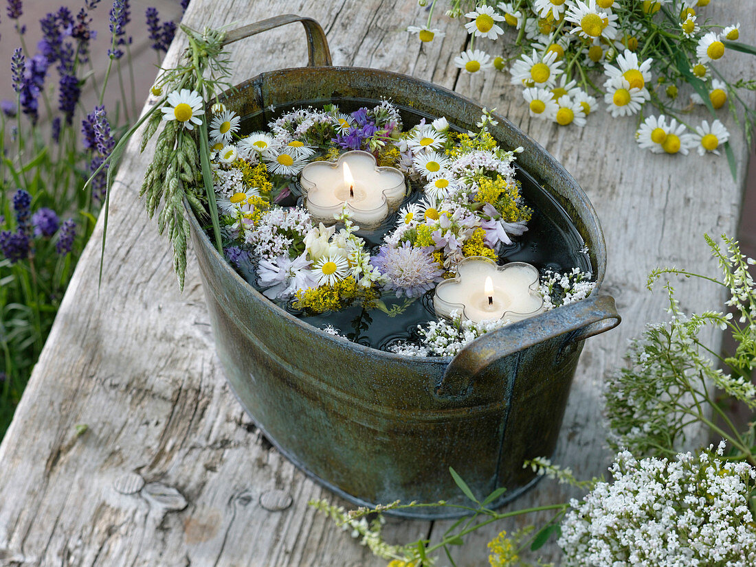 Small meadow flowers wreath in the water