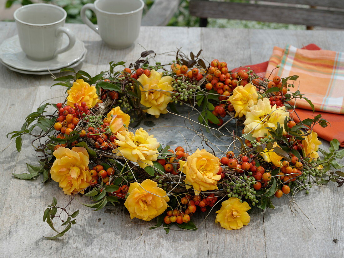 Wreath of pink 'Tequila' (roses), Sorbus aucuparia (rowan berries)