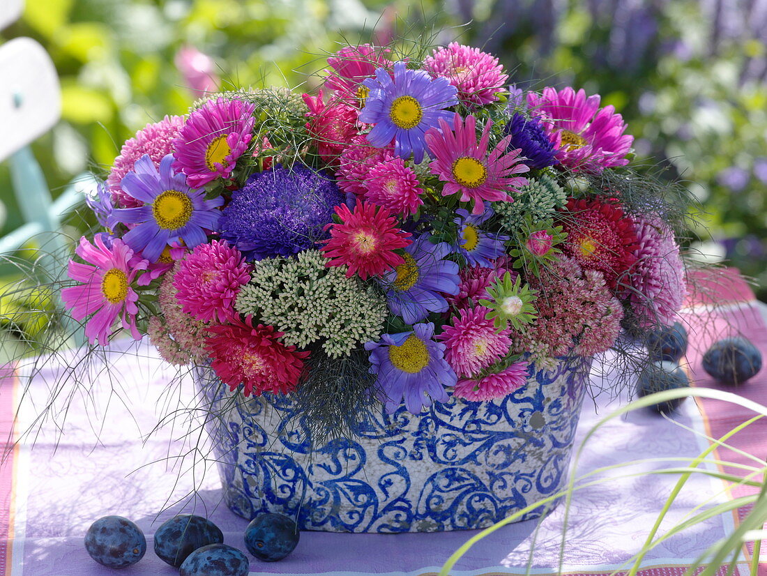 Arrangement of summer asters, stonecrop and fennel