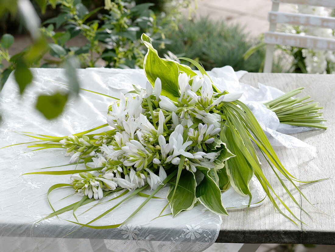 Fragrant wedding bouquet of lilies Funkie with grass bow