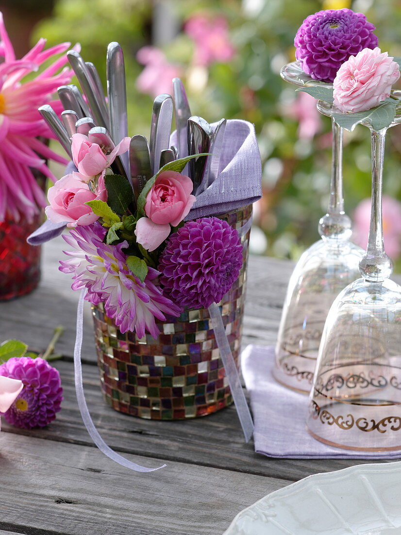 Glass with cutlery and bouquet