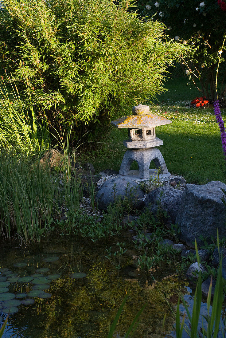 Japanese stone lantern by the pond