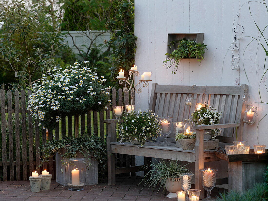 White evening terrace with lanterns and candles