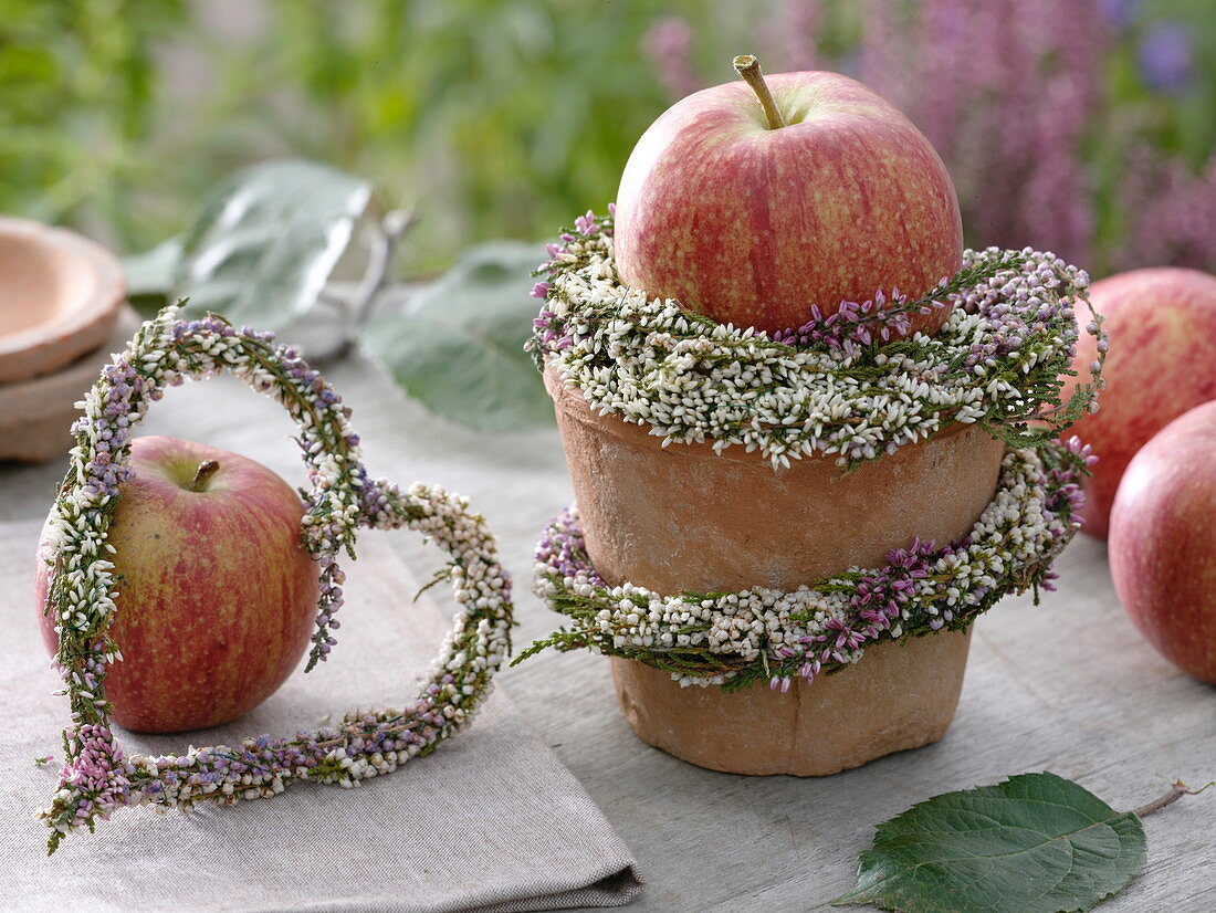 Small table decoration with apples and broom heather