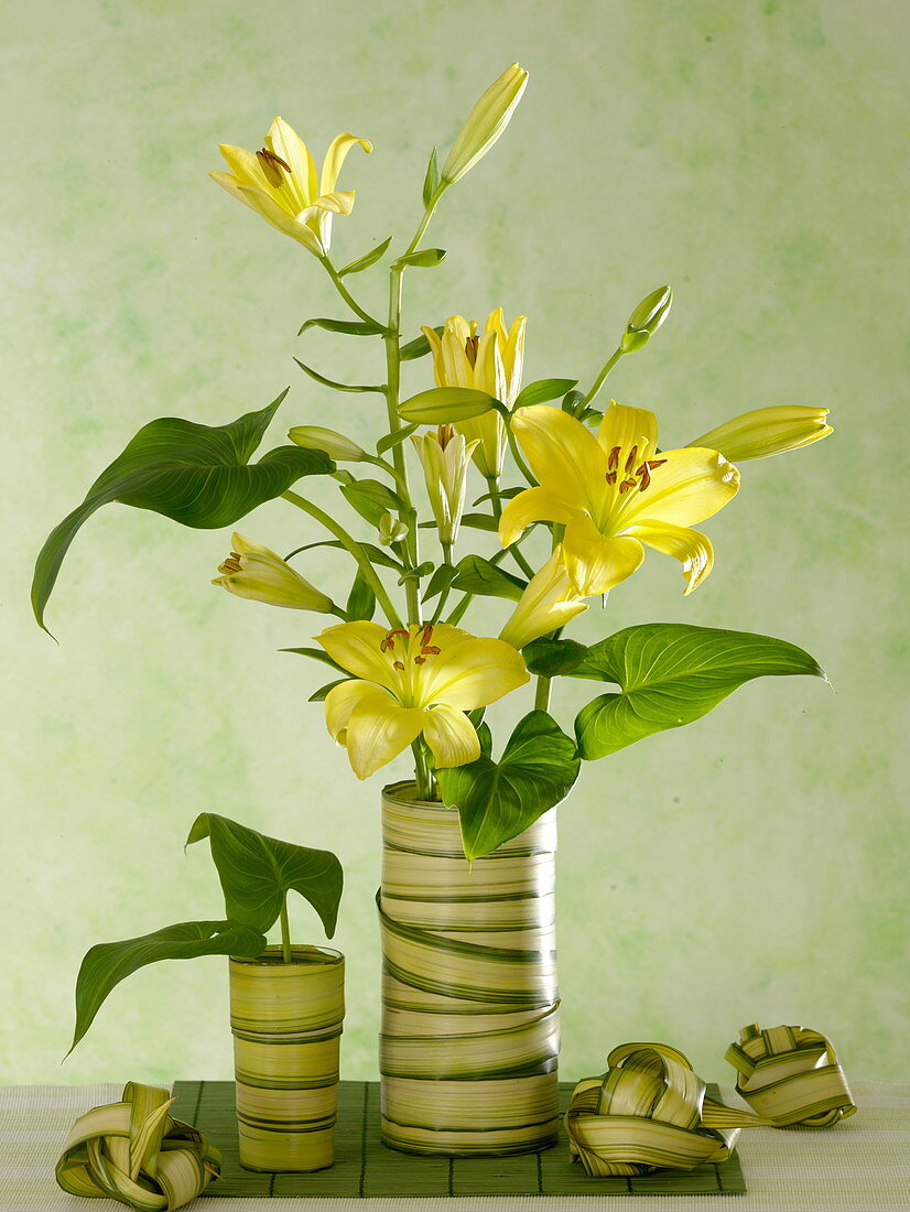 Bouquet of yellow Lilium (lilies) with leaves of Zantedeschia (calla)