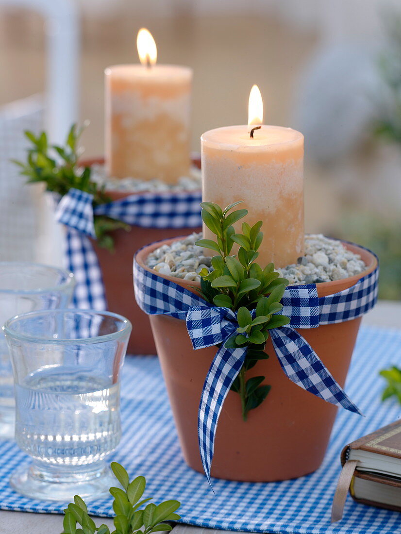 Clay pots filled with grit stones as candle holders